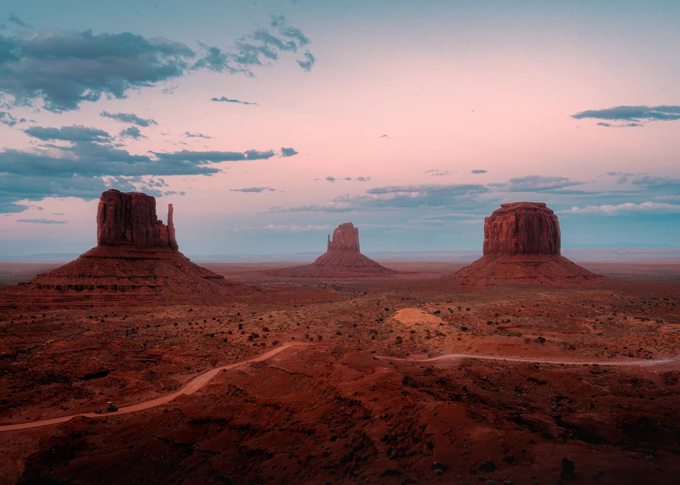 Monument Valley buttes under a pastel dusk sky