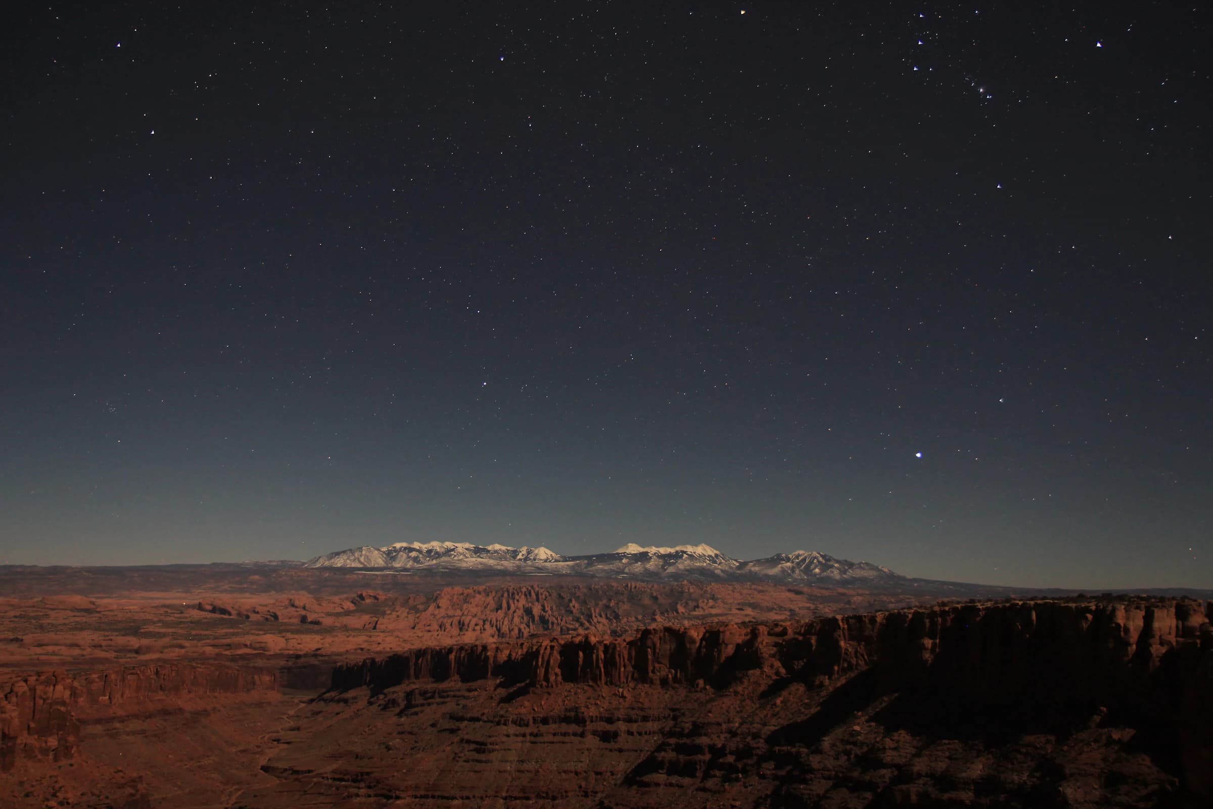 Stars over a quiet desert canyon at night